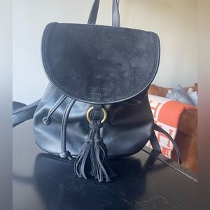 Small Black Leather Backpack with black velvet closing.